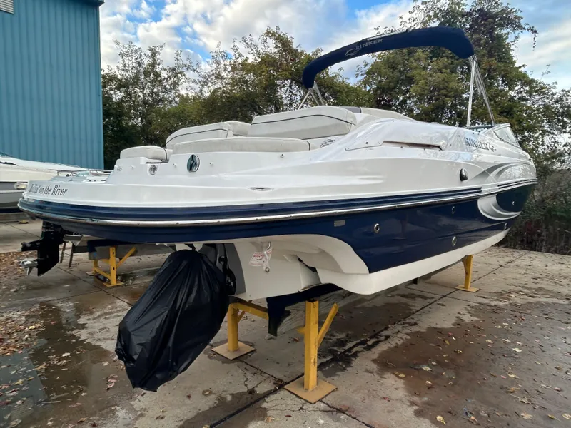 Slide: The Image of 2015 Rinker Captiva 276 BR boat on stands, outdoors, with blue and white design. - 6