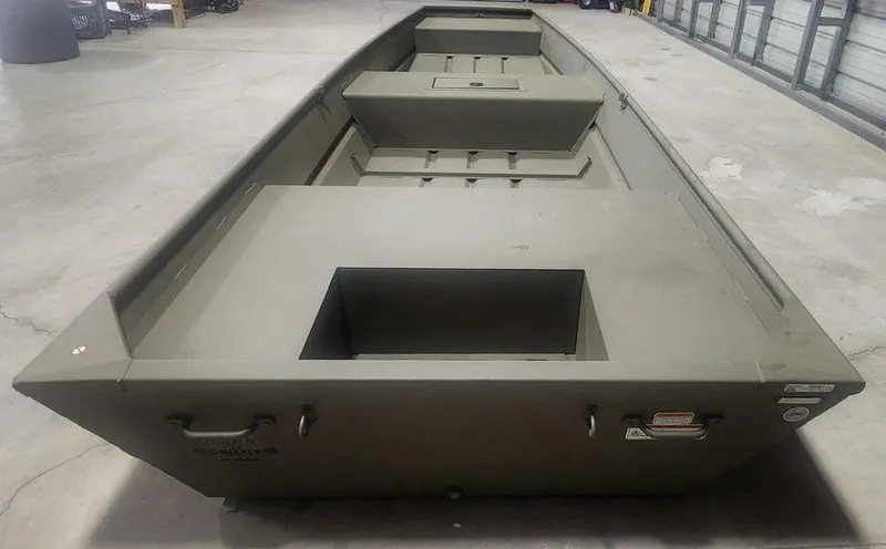 Slide: The Image of 2025 Tracker Jon 1542 LW Topper boat in a garage setting. - 3