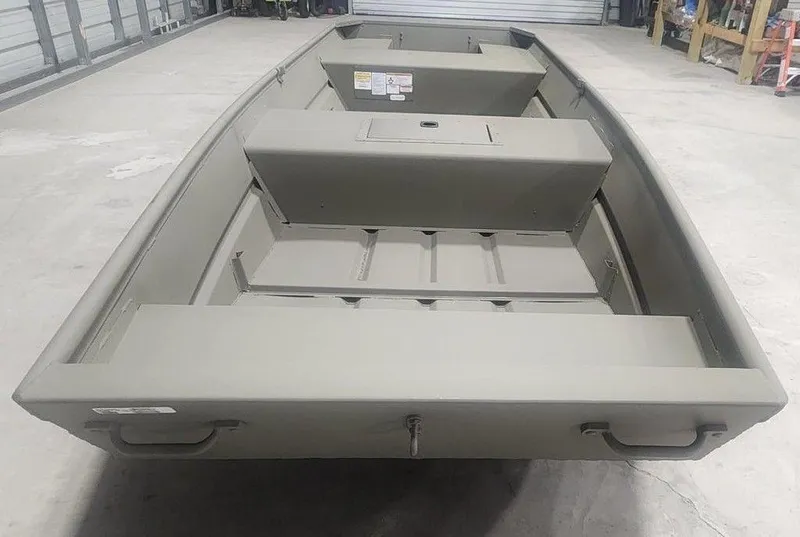 Slide: The Image of 2025 Tracker Jon 1542 LW Topper boat in a garage setting. - 4