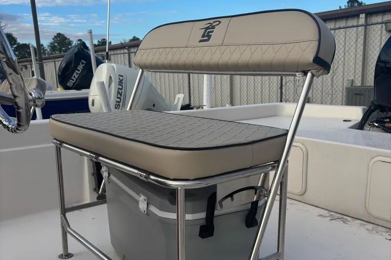 Slide: The Image of 2024 Carolina Skiff E21 DLX CC boat seat with storage and Suzuki outboard motor. - 4