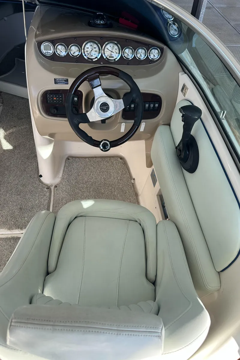 Slide: The Image of 2002 Chaparral 263 Sunesta boat cockpit with steering wheel and gauges. - 15