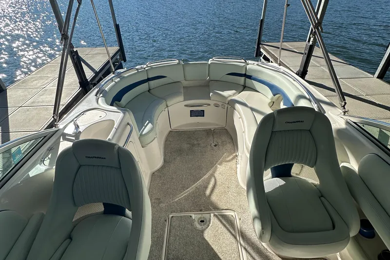 Slide: The Image of 2002 Chaparral 263 Sunesta boat interior with plush seating and lake view. - 17