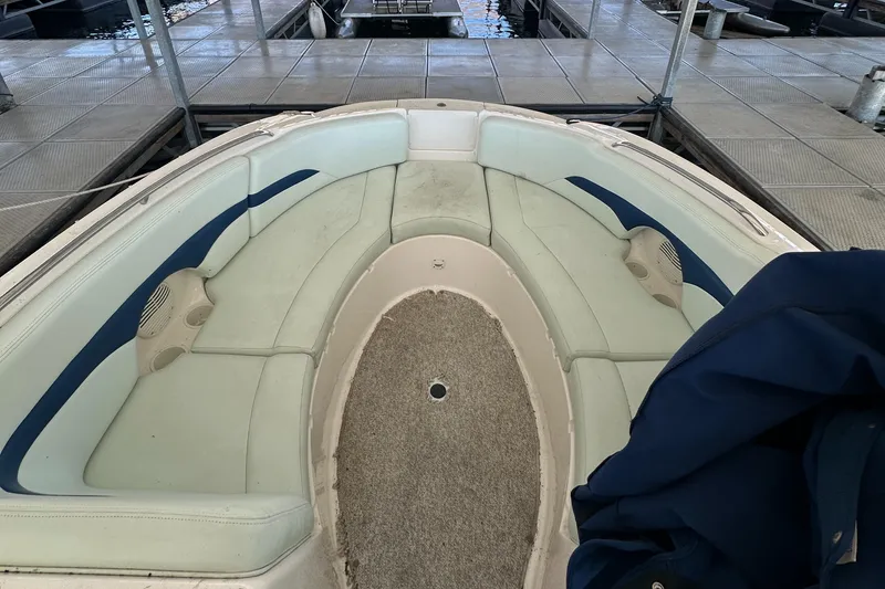 Slide: The Image of 2002 Chaparral 263 Sunesta boat interior with spacious seating and carpeted floor. - 22