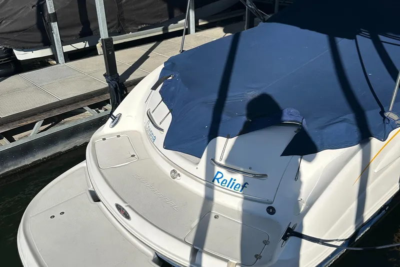 Slide: The Image of 2002 Chaparral 263 Sunesta boat docked with blue cover. - 8