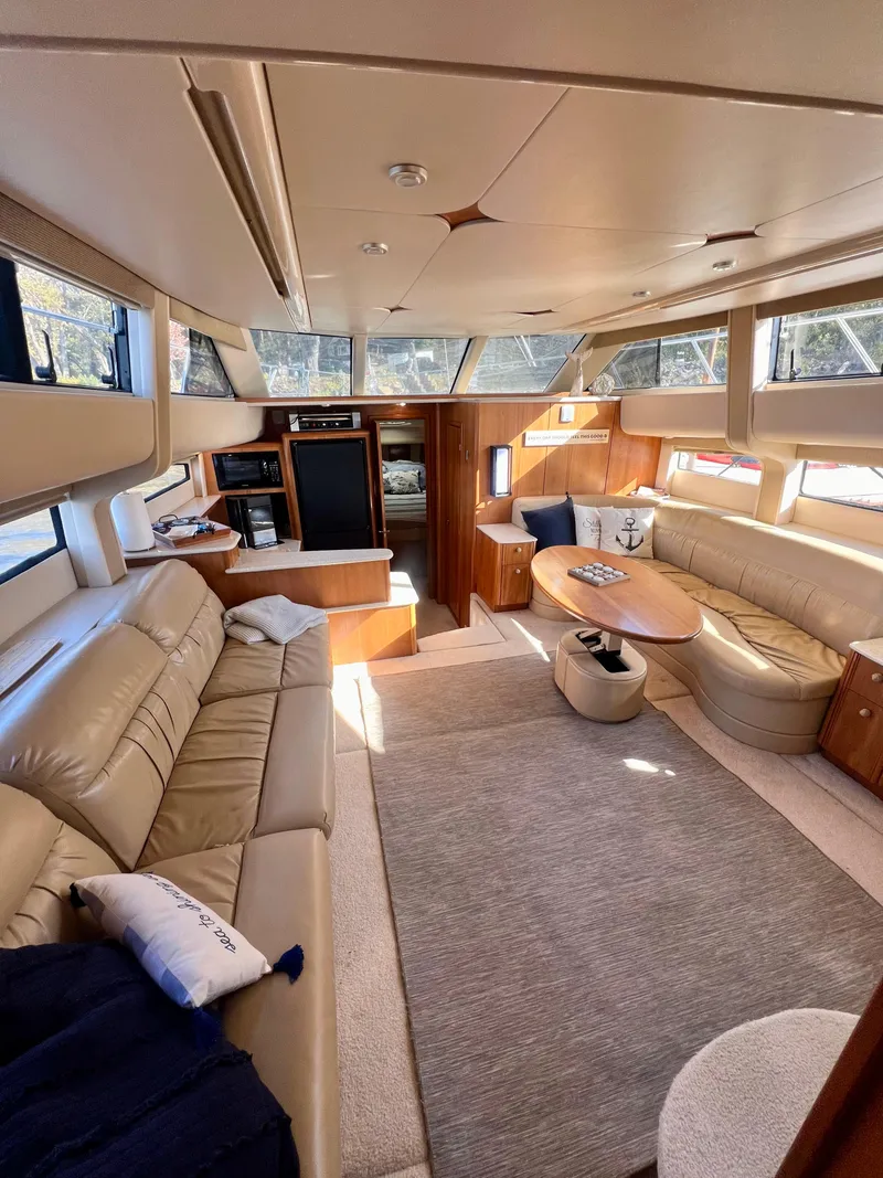 Slide: The Image of Luxurious 2004 Meridian 459 Motoryacht bedroom with striped bedding and natural light. - 10