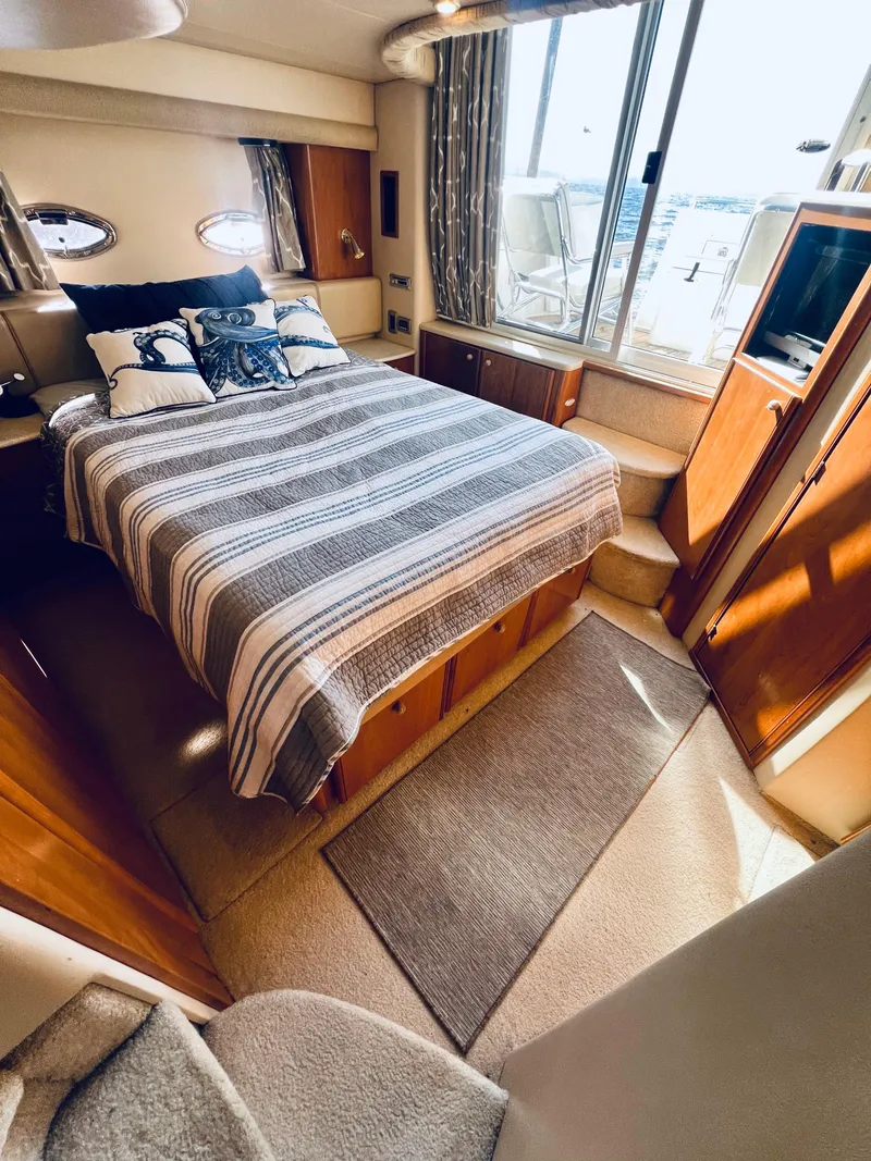 Slide: The Image of 2004 Meridian 459 Motoryacht interior with bed, sink, and window view. - 11