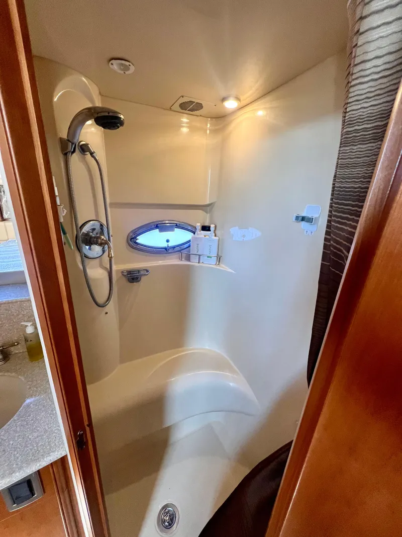 Slide: The Image of 2004 Meridian 459 Motoryacht bathroom with shower, sink, and toilet. - 13