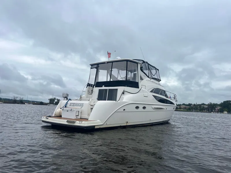 Slide: The Image of 2004 Meridian 459 Motoryacht docked by a lake with a hot air balloon overhead. - 3