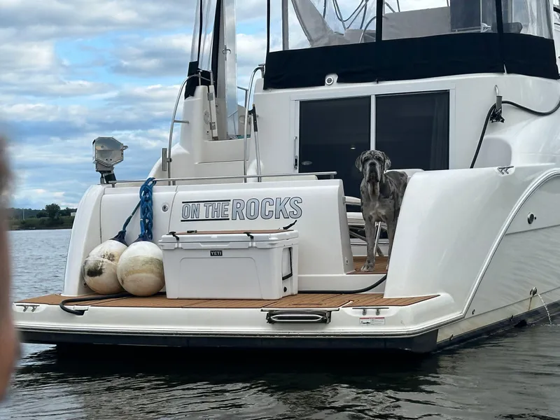 Slide: The Image of 2004 Meridian 459 Motoryacht on stands, surrounded by trees and blue tarps. - 5
