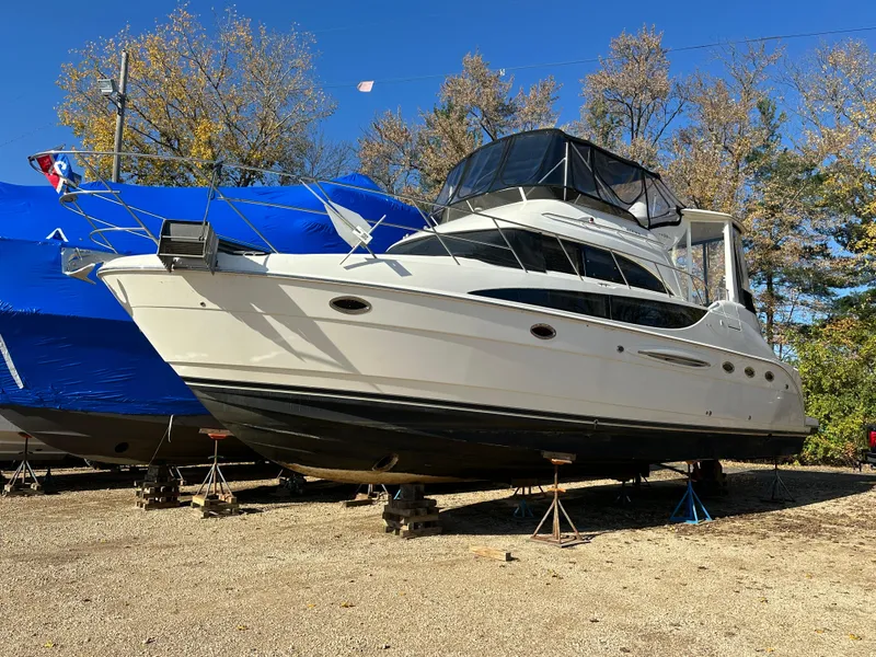 Slide: The Image of Cozy bedroom in 2004 Meridian 459 Motoryacht with striped bedding and porthole windows. - 6