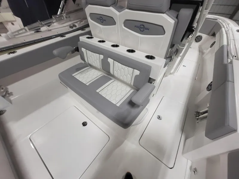 Slide: The Image of 2022 Fountain 38 SC boat interior with gray and white seating and cup holders. - 13