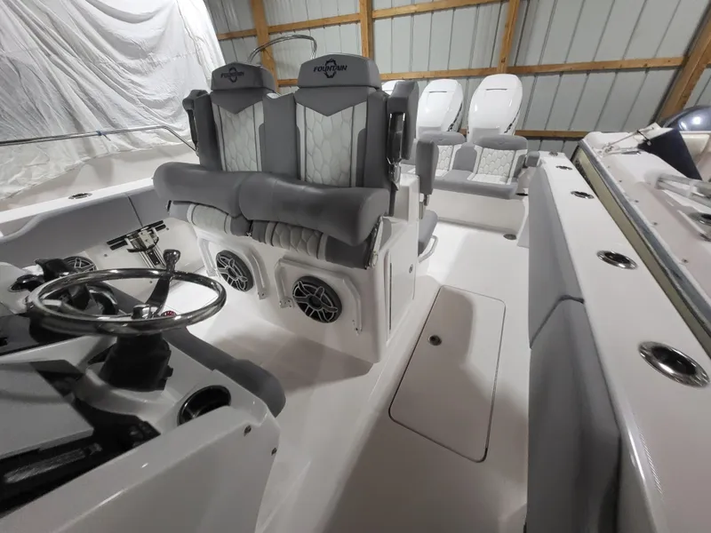 Slide: The Image of 2022 Fountain 38 SC boat interior with modern seating and steering wheel. - 16