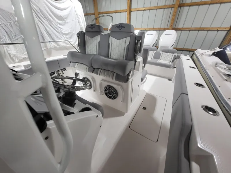 Slide: The Image of 2022 Fountain 38 SC boat interior with modern seating and steering wheel. - 17