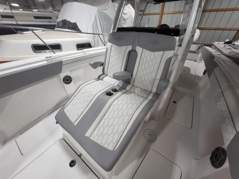 Slide: The Image of 2022 Fountain 38 SC boat interior with white and gray seating. - 20
