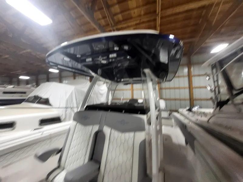 Slide: The Image of 2022 Fountain 38 SC boat interior with seating and console in a storage facility. - 21