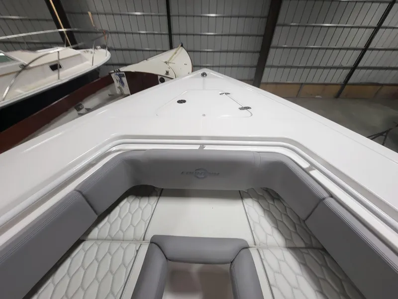 Slide: The Image of 2022 Fountain 38 SC boat interior with sleek seating in a storage facility. - 27