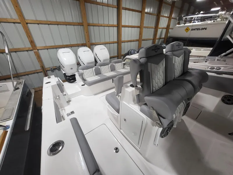Slide: The Image of 2022 Fountain 38 SC boat interior with triple outboard engines in a storage facility. - 29