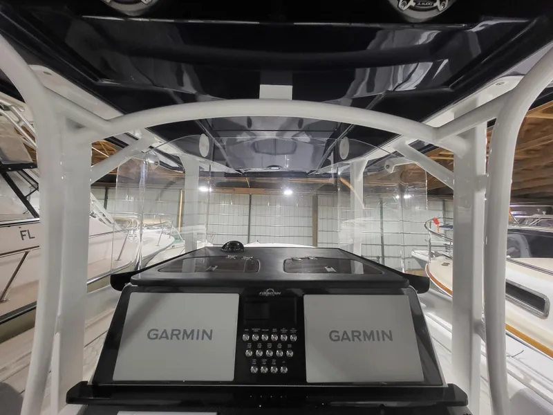 Slide: The Image of 2022 Fountain 38 SC boat cockpit with dual Garmin displays in a showroom. - 35
