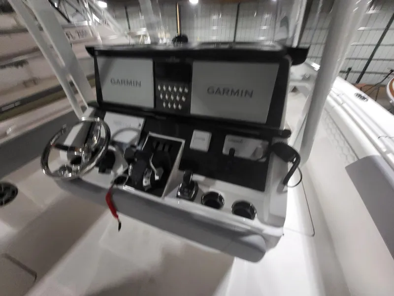 Slide: The Image of 2022 Fountain 38 SC boat dashboard with dual Garmin displays and steering wheel. - 39