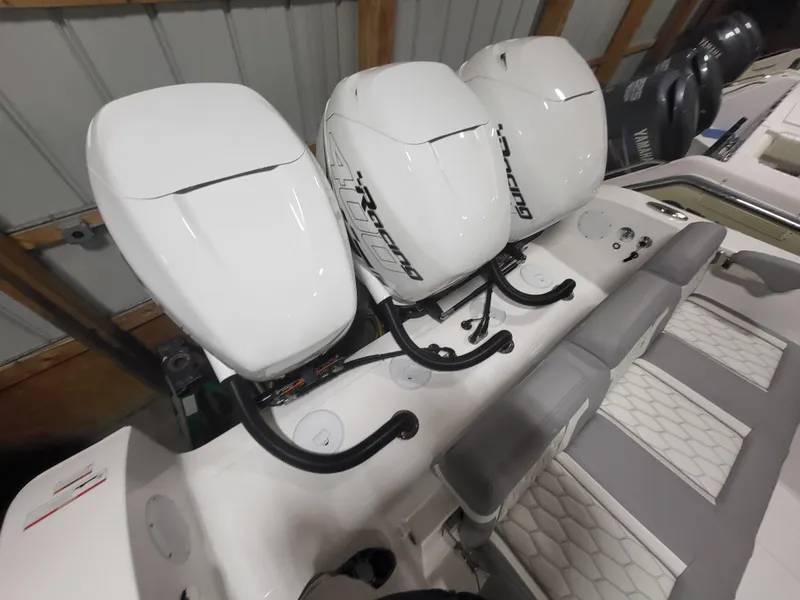 Slide: The Image of 2022 Fountain 38 SC boat with triple outboard engines in a storage facility. - 5