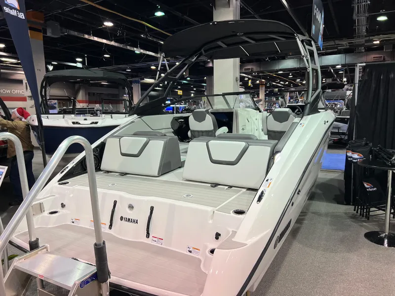 Slide: The Image of 2025 Yamaha Boats AR250 displayed at a boat show, featuring sleek design and modern seating. - 4