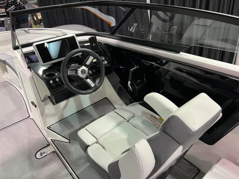 Slide: The Image of 2025 Yamaha AR250 boat interior with modern dashboard and steering wheel. - 6