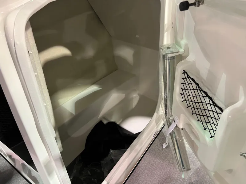 Slide: The Image of Interior storage compartment of 2025 Yamaha Boats AR250 with netted pocket and metallic support. - 9
