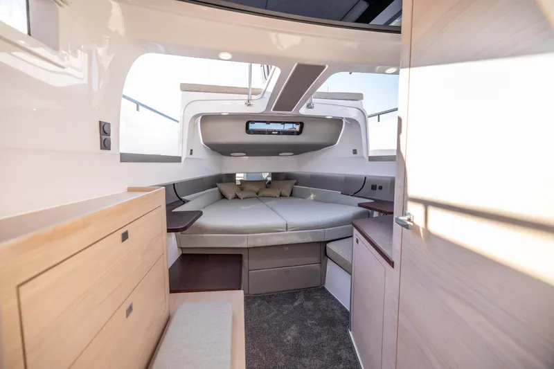 Slide: The Image of Luxurious interior of 2025 Axopar 45 boat with modern furnishings and cozy seating area. - 11