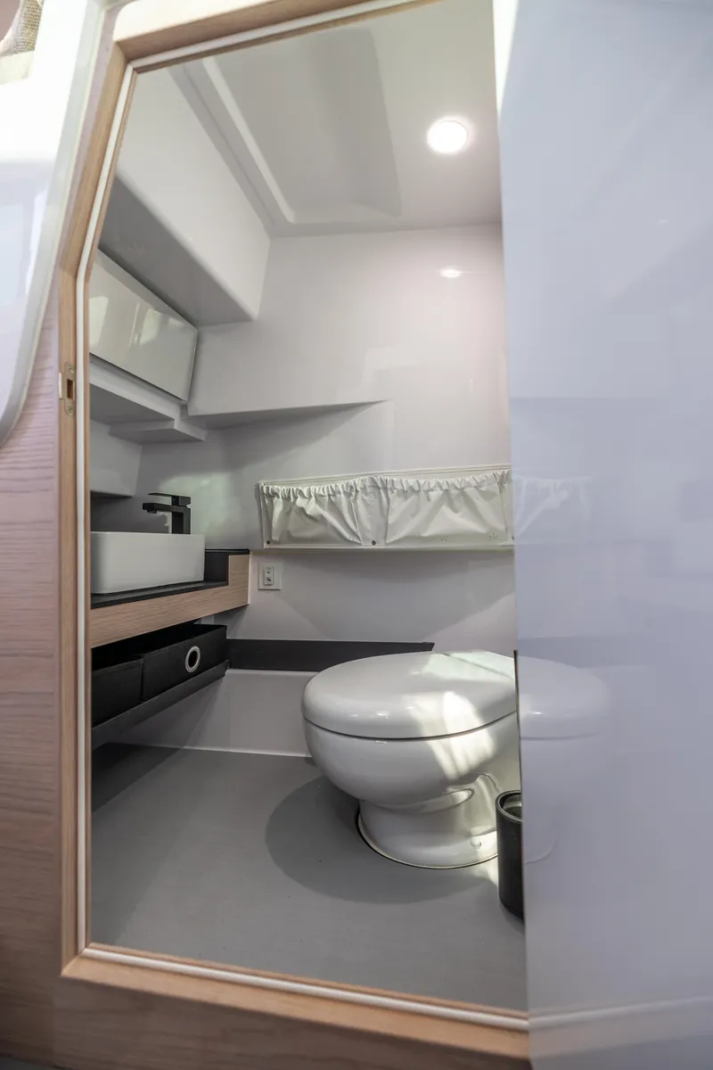 Slide: The Image of Modern bathroom interior of 2025 Axopar 45 boat, featuring sleek design and compact amenities. - 12