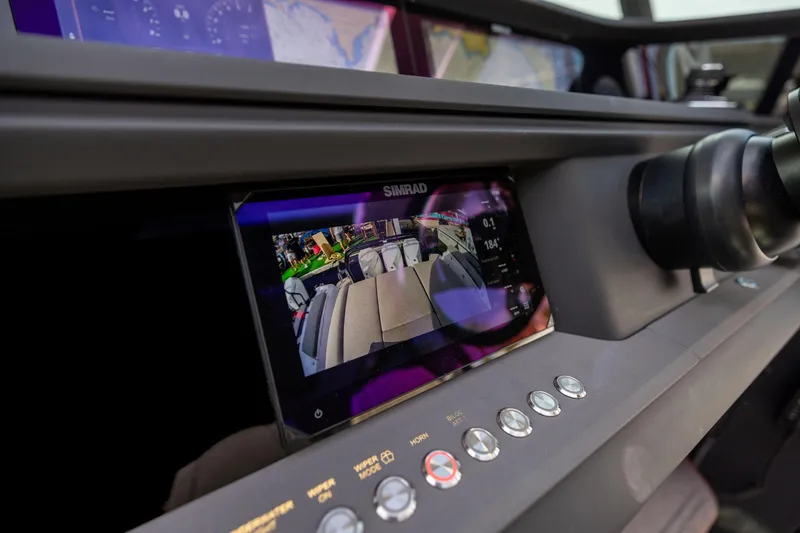 Slide: The Image of Dashboard of 2025 Axopar 45 with Simrad display and control buttons. - 4