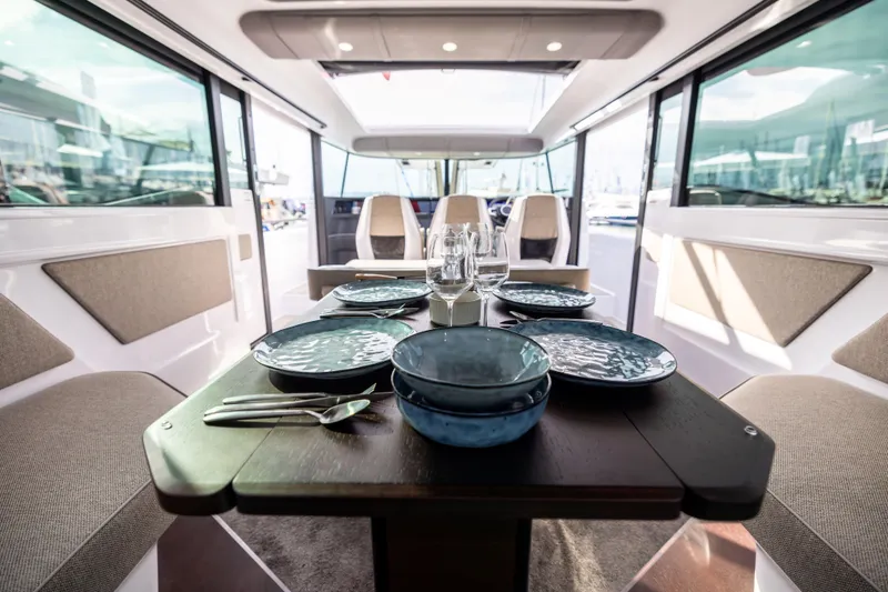 Slide: The Image of Luxurious interior of 2025 Axopar 45 boat with elegant dining setup. - 7