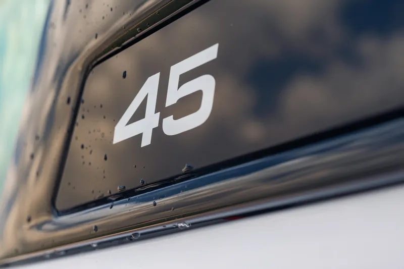 Slide: The Image of Close-up of Axopar 45 XC Cross Cabin 2025 model number with raindrops. - 50