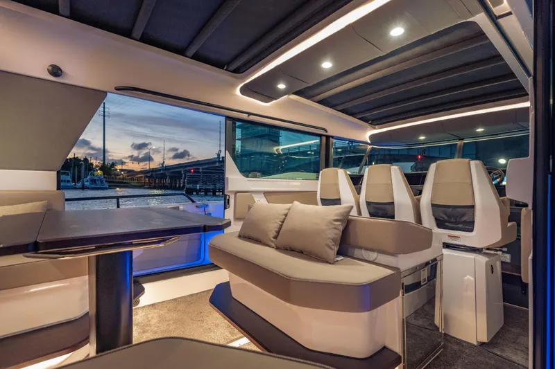 Slide: The Image of Luxurious interior of 2025 Axopar 45 XC Cross Cabin at sunset, featuring modern seating and ambient lighting. - 31