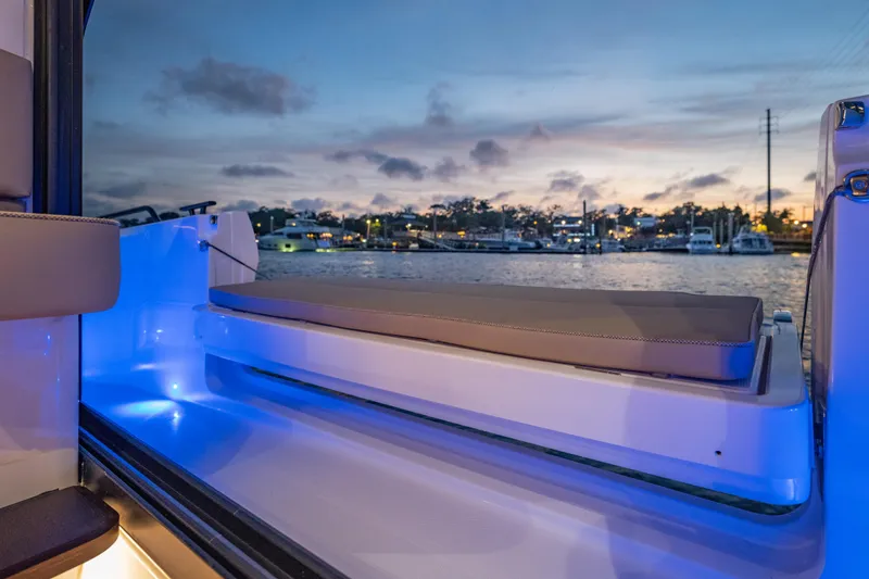 Slide: The Image of 2025 Axopar 45 XC Cross Cabin interior with ambient blue lighting at sunset. - 24