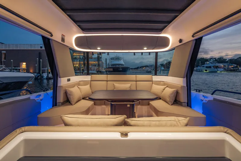 Slide: The Image of Luxurious interior of 2025 Axopar 45 XC Cross Cabin yacht at sunset, featuring plush seating. - 36