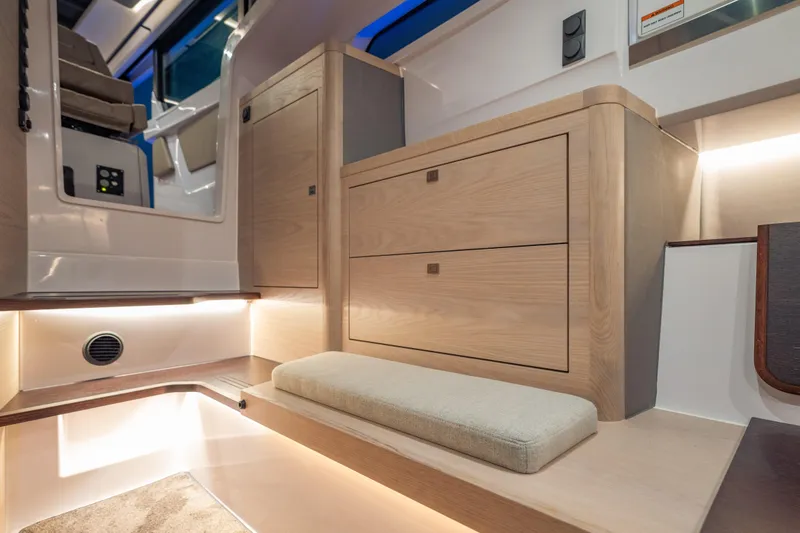 Slide: The Image of Luxurious interior of 2025 Axopar 45 XC Cross Cabin with modern wood cabinetry. - 47