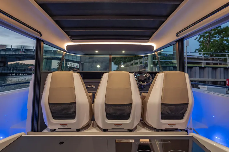Slide: The Image of Interior view of 2025 Axopar 45 XC Cross Cabin with modern seating and steering wheel. - 32
