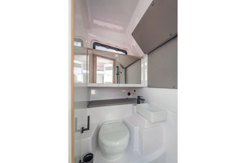 Slide: The Image of Modern bathroom in 2025 Axopar 45 XC Cross Cabin boat, featuring sleek design and compact fixtures. - 51