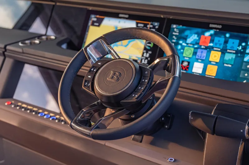 Slide: The Image of Steering wheel and dashboard of 2025 Axopar 45 XC Cross Cabin with digital displays. - 34