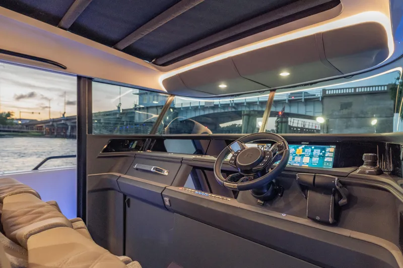Slide: The Image of Interior view of 2025 Axopar 45 XC Cross Cabin, featuring modern dashboard and steering wheel. - 33