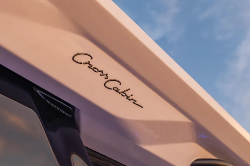 Slide: The Image of 2025 Axopar 45 XC Cross Cabin logo against a clear blue sky. - 49