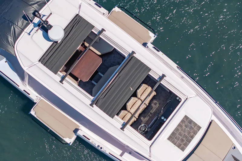 Slide: The Image of Overhead view of 2025 Axopar 45 XC Cross Cabin on water, showcasing sleek design. - 14