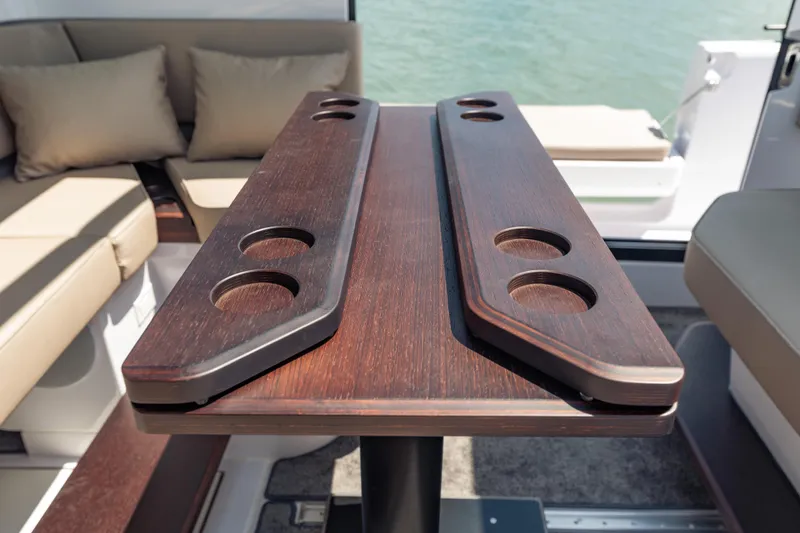Slide: The Image of Luxurious interior of 2025 Axopar 45 XC Cross Cabin with elegant wooden table and seating. - 38