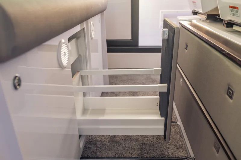 Slide: The Image of Interior storage drawer of 2025 Axopar 45 XC Cross Cabin boat. - 45
