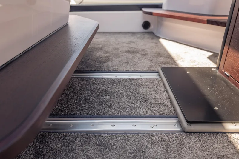 Slide: The Image of Interior view of 2025 Axopar 45 XC Cross Cabin with carpeted flooring and sleek design. - 40