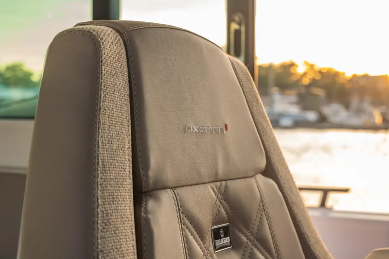 Slide: The Image of Luxurious seat detail in 2025 Axopar 45 XC Cross Cabin boat at sunset. - 39