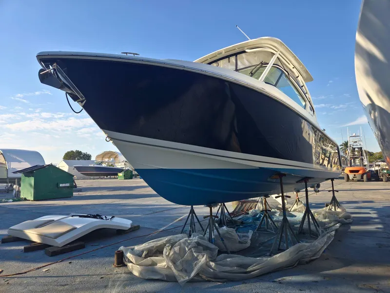 Slide: The Image of 2020 Pursuit 266 boat on stands in a marina setting. - 1