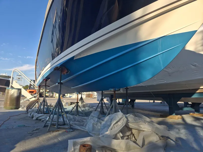 Slide: The Image of 2020 Pursuit 266 boat on stands, undergoing maintenance with blue hull visible. - 13