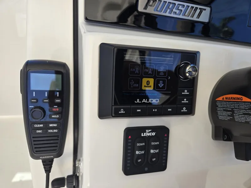 Slide: The Image of Control panel of a 2020 Pursuit 266 boat with radio and audio system. - 14