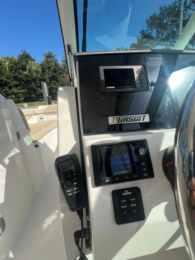 Slide: The Image of 2020 Pursuit 266 boat dashboard with navigation controls and display. - 20
